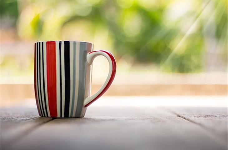 cup with a hinged lid crossword